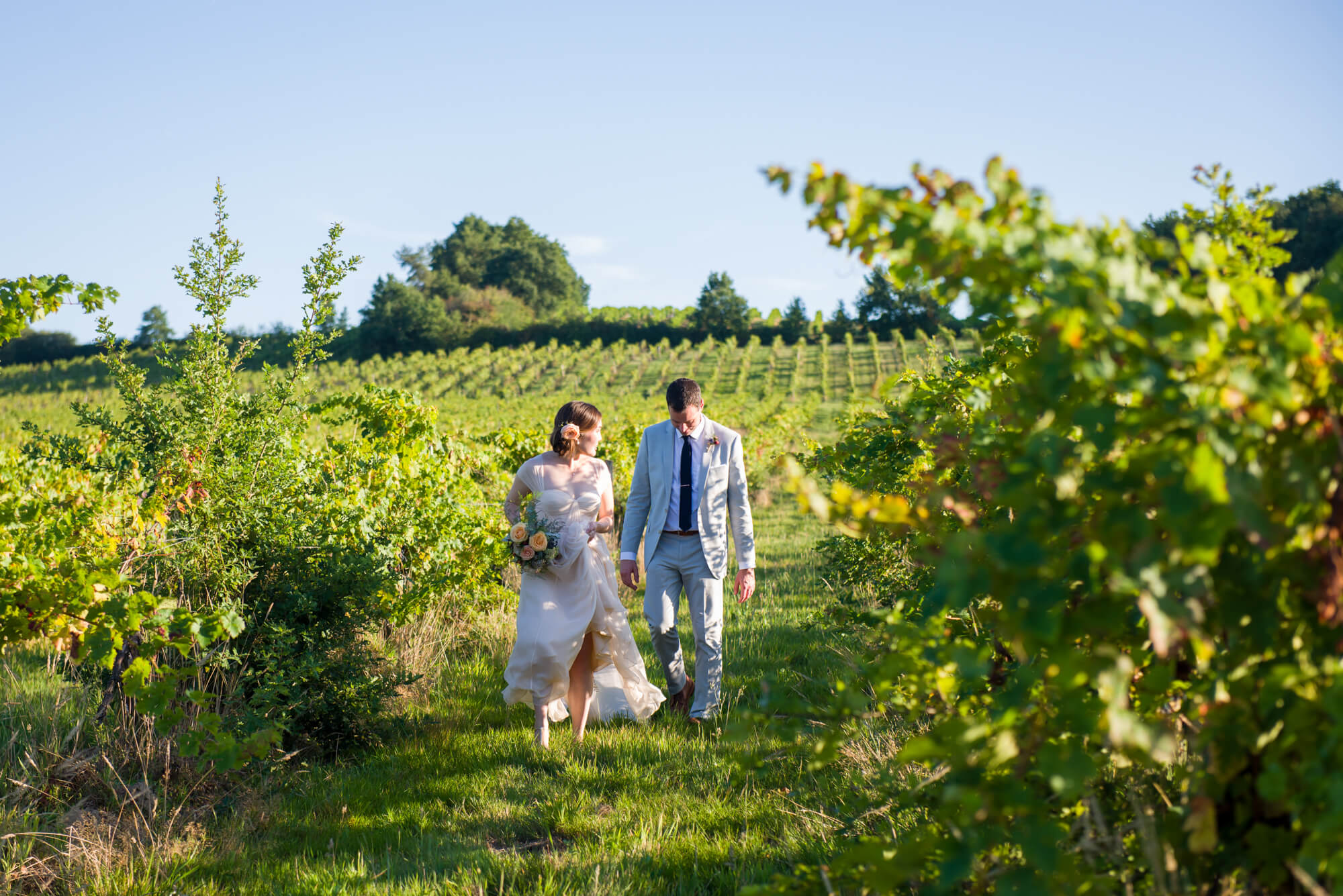 bride and groom in the vines at chateau riguad