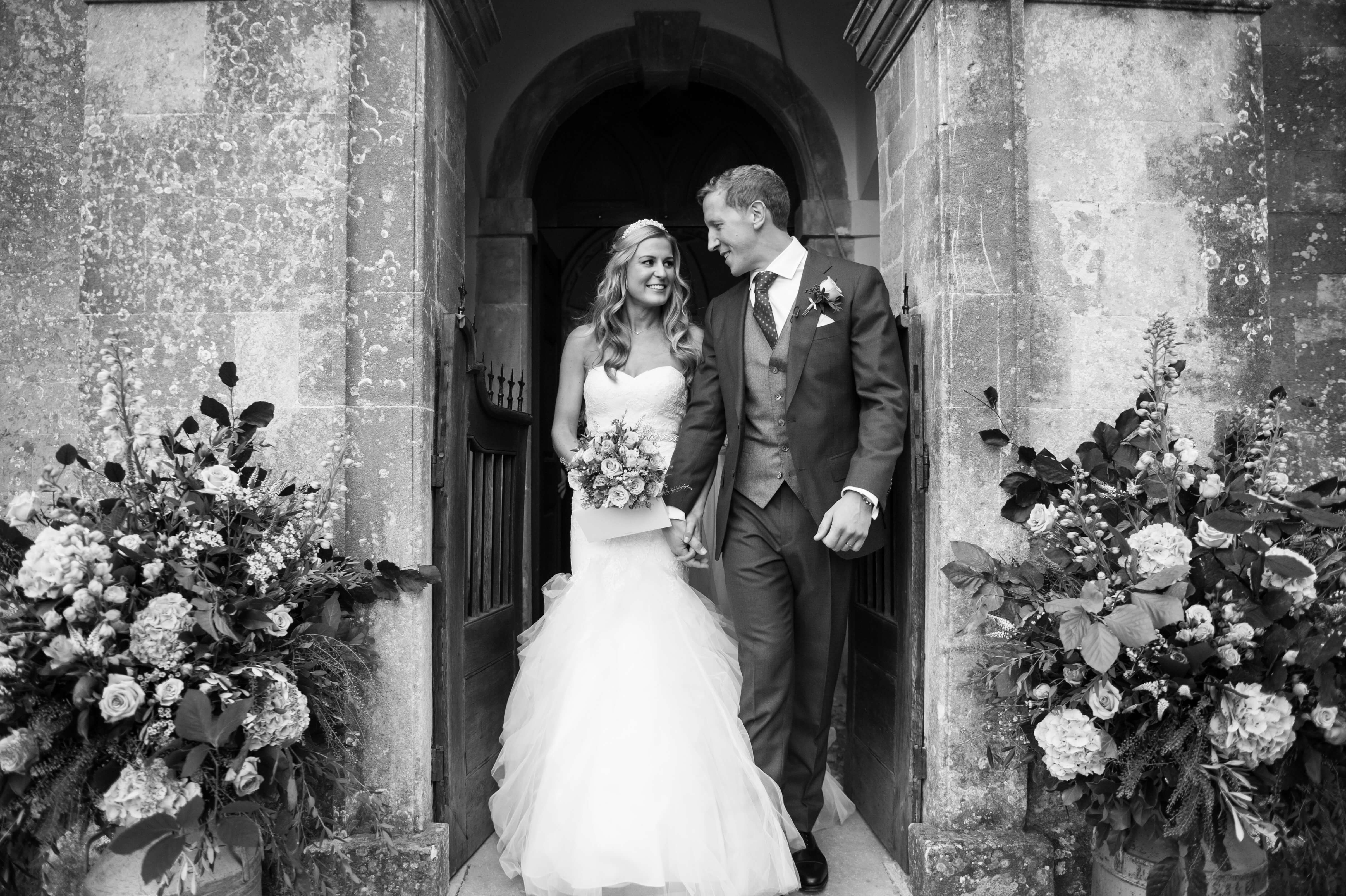 coupel exiting the chapel at babington house in someset by especially amy wedding photographer