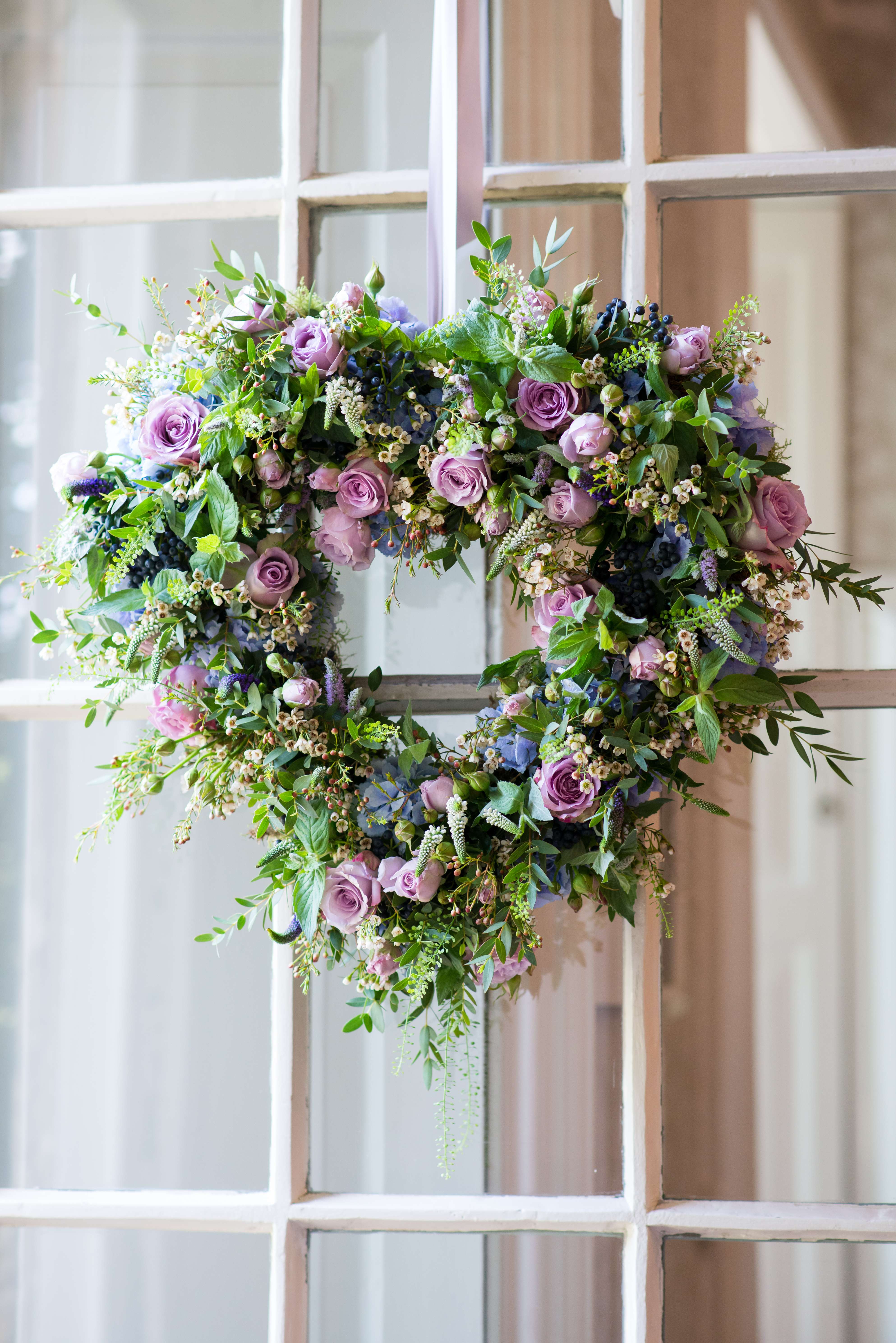 love heart wreath on the door at babington house created by flowers by passion