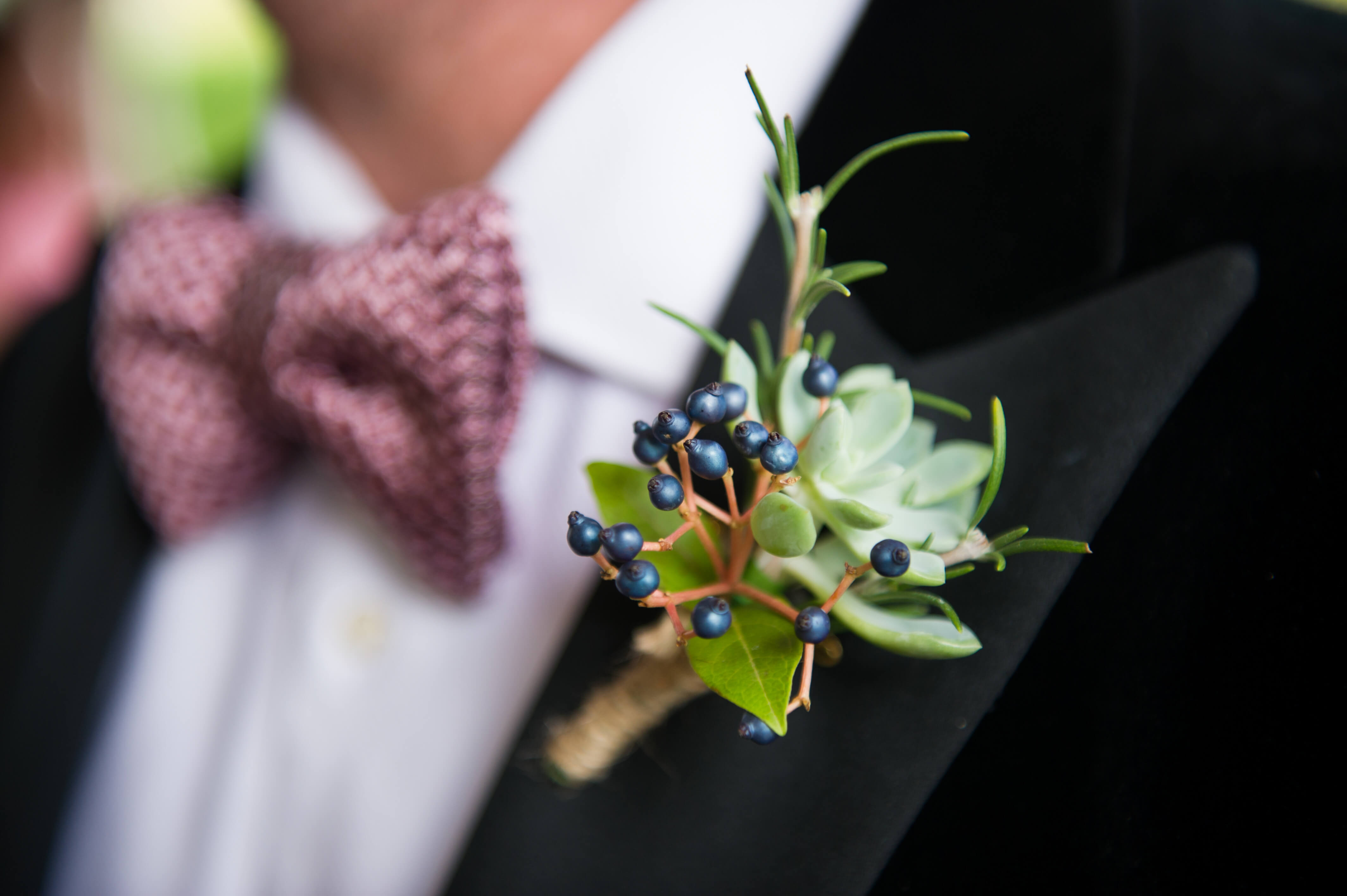 groom wearing an autumnal berries buttonhole and tom ford bowtie