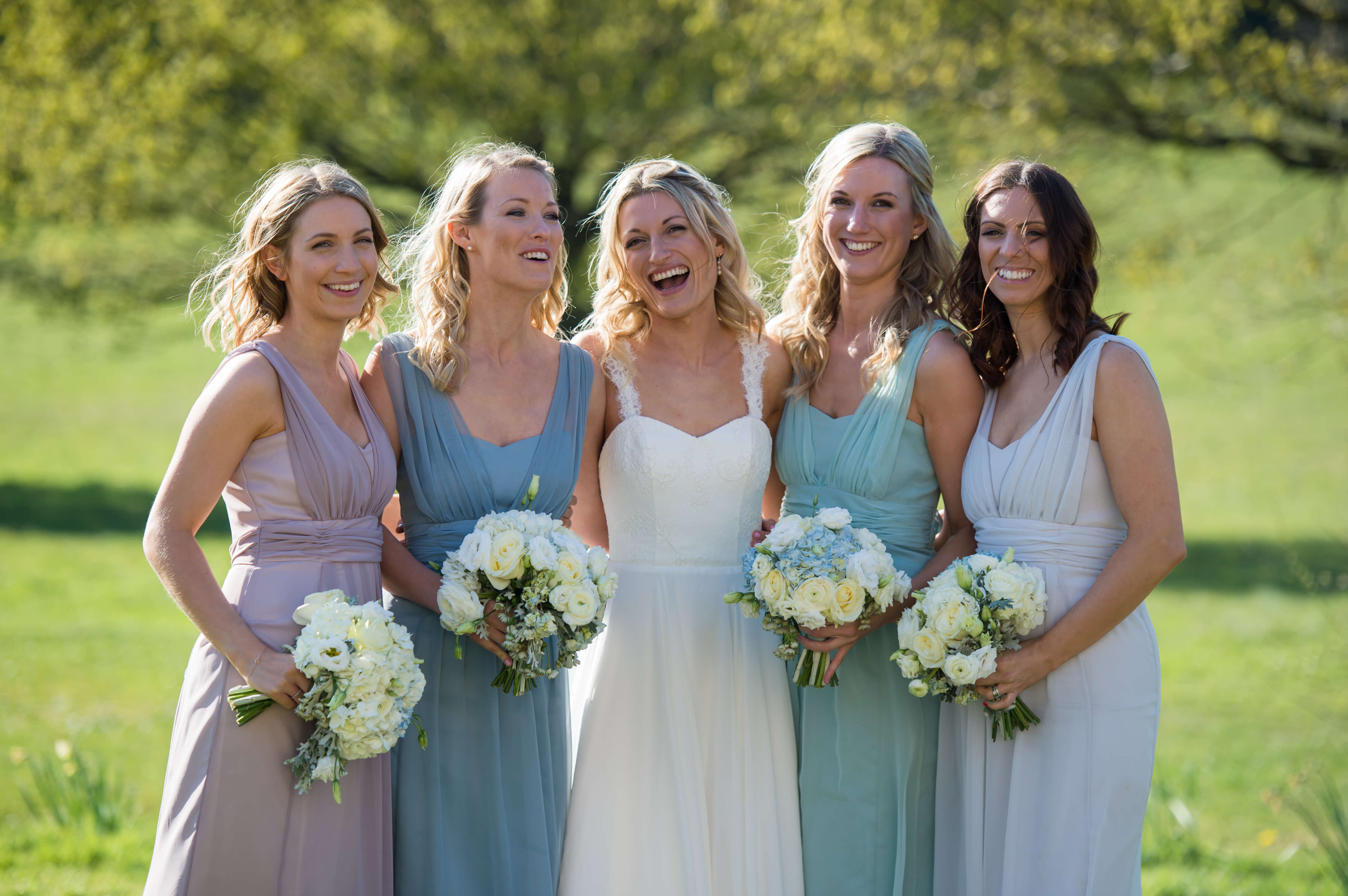 bride and bridesmaids laughing at botleys mansion