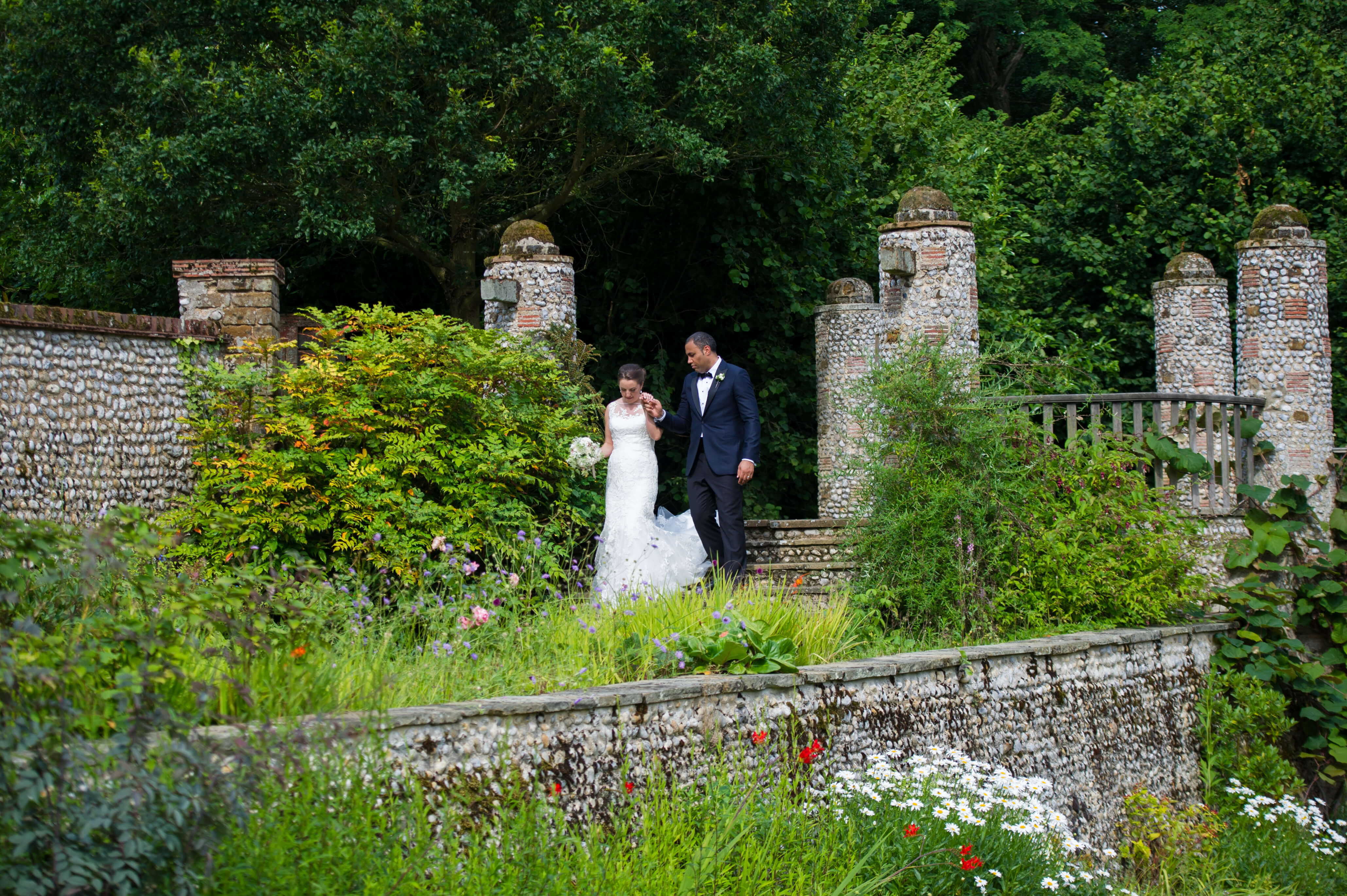 bride and groom in the grounds at their voewood wedding in norfolk