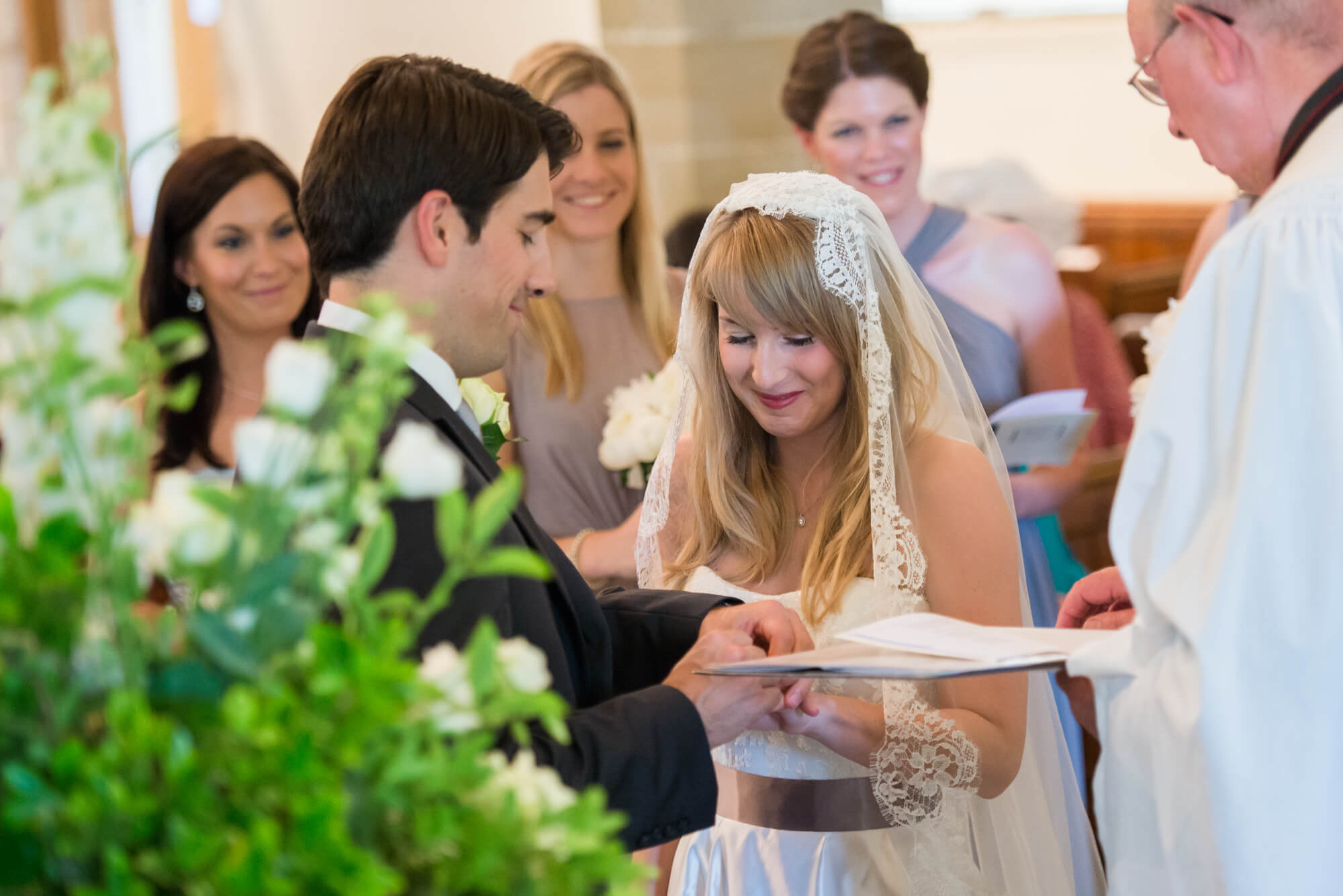 A couple exchanging rings in a church in Sussex