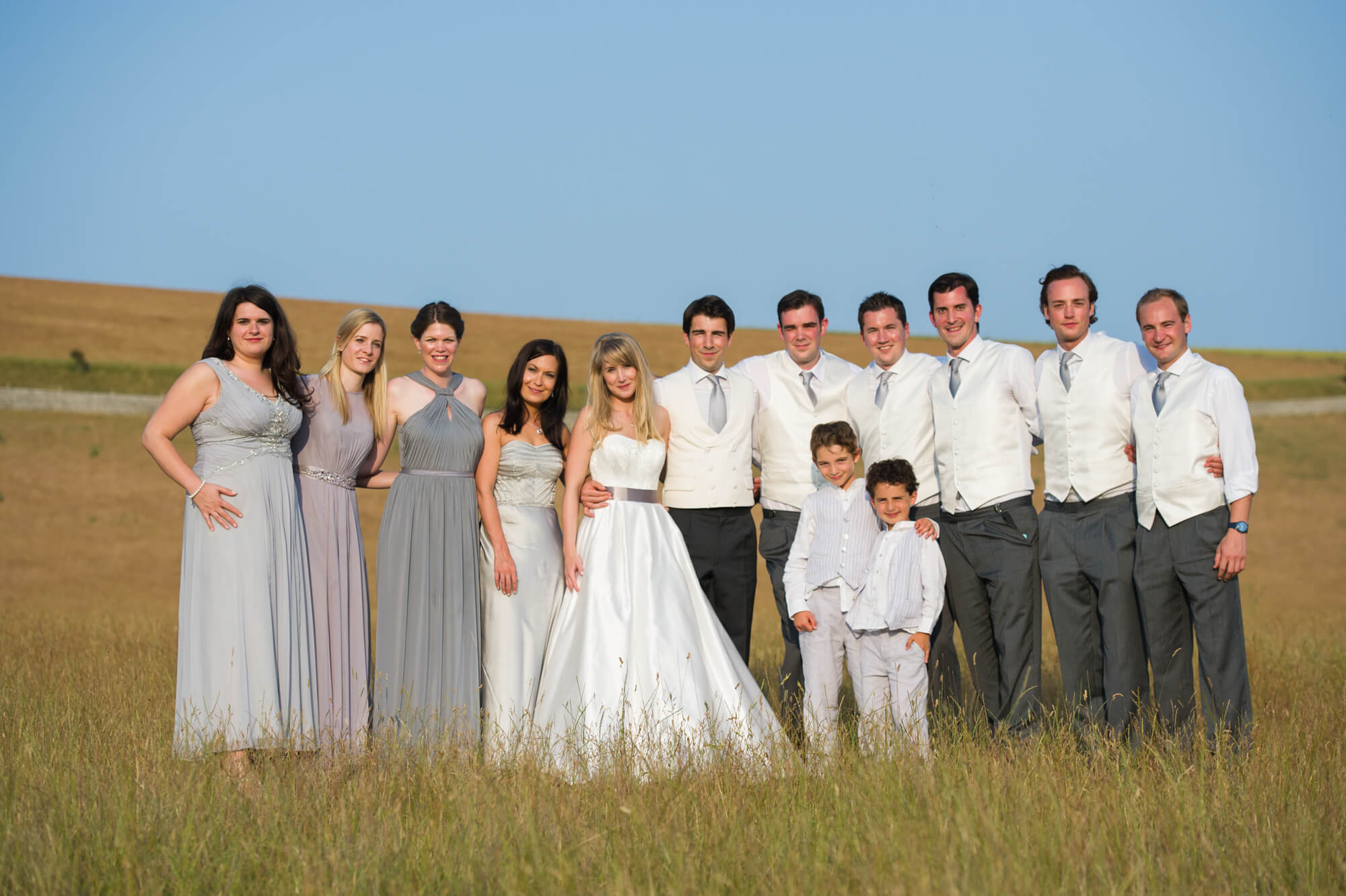 A bridal party having their photos taken in the Sussex countryside