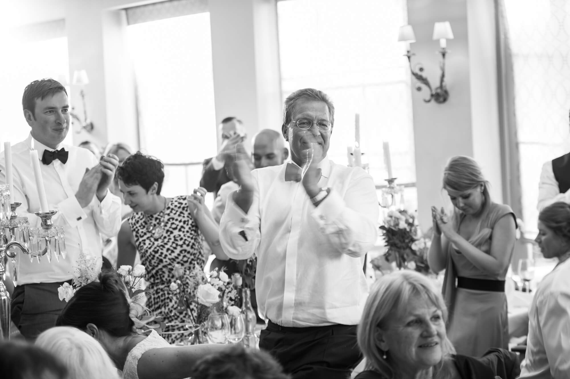 guests applauding speeches at babington house wedding
