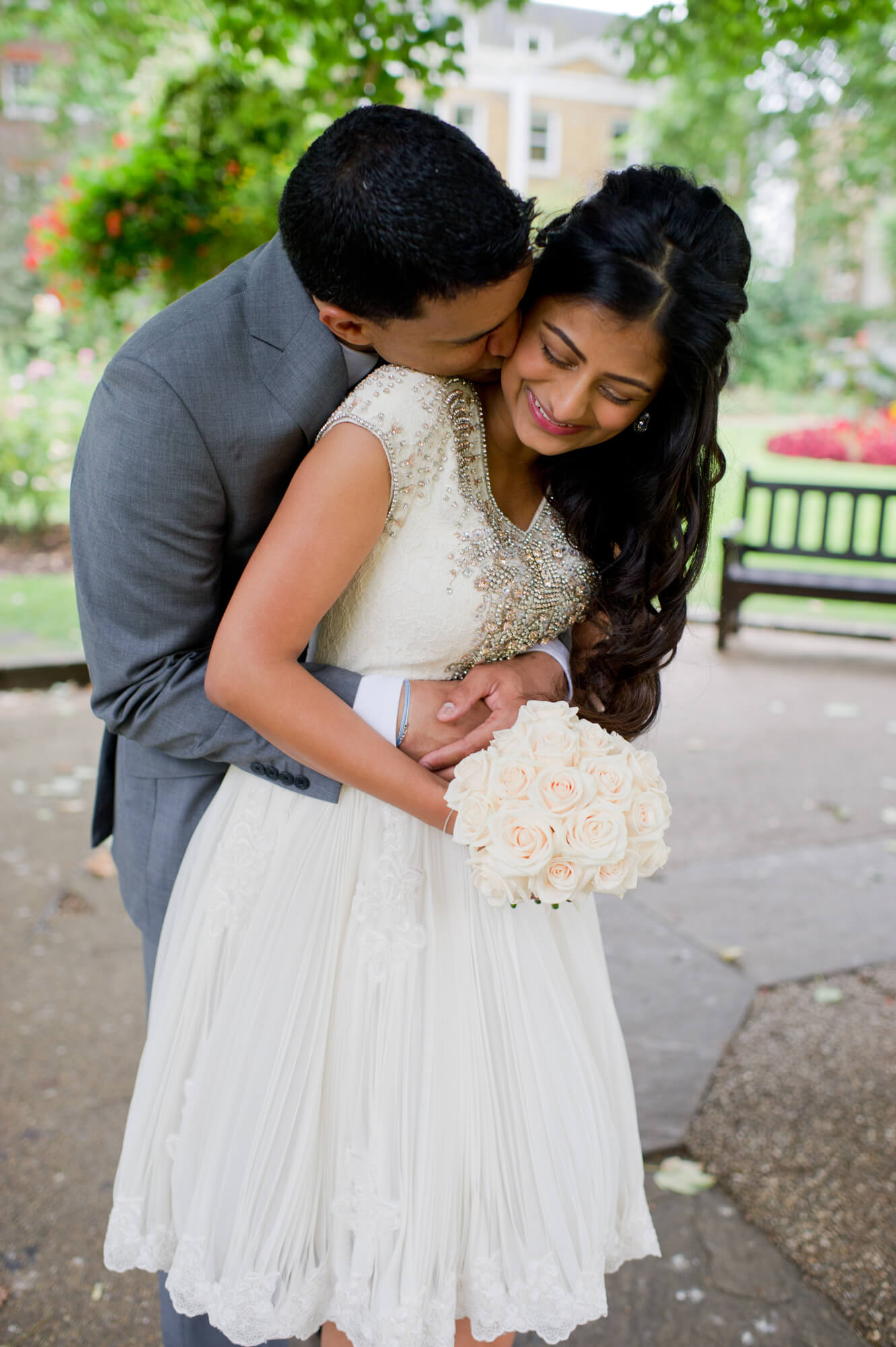 A bride and groom hugging in a park in Chelsea