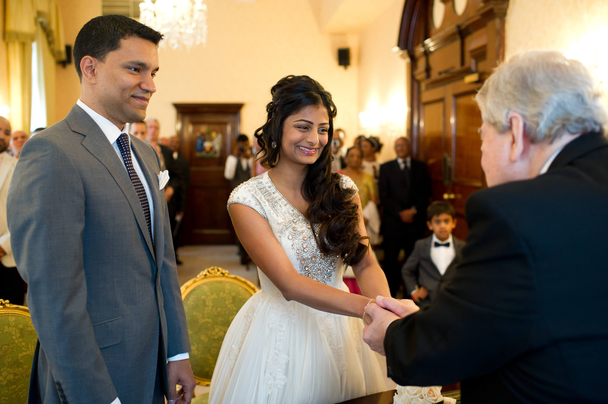 A couple exchanging rings at Chelsea Old Town Hall