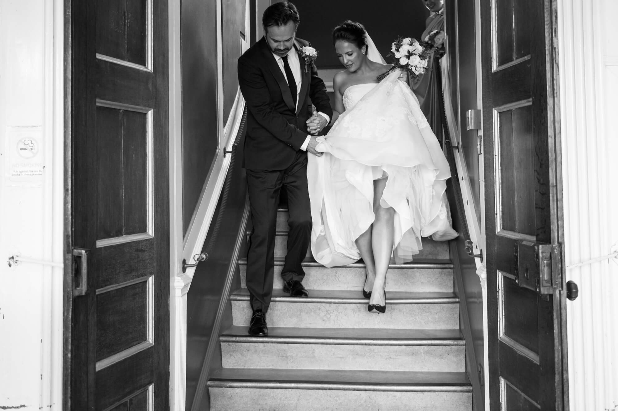 A just married couple walking down the steps at Rye town hall