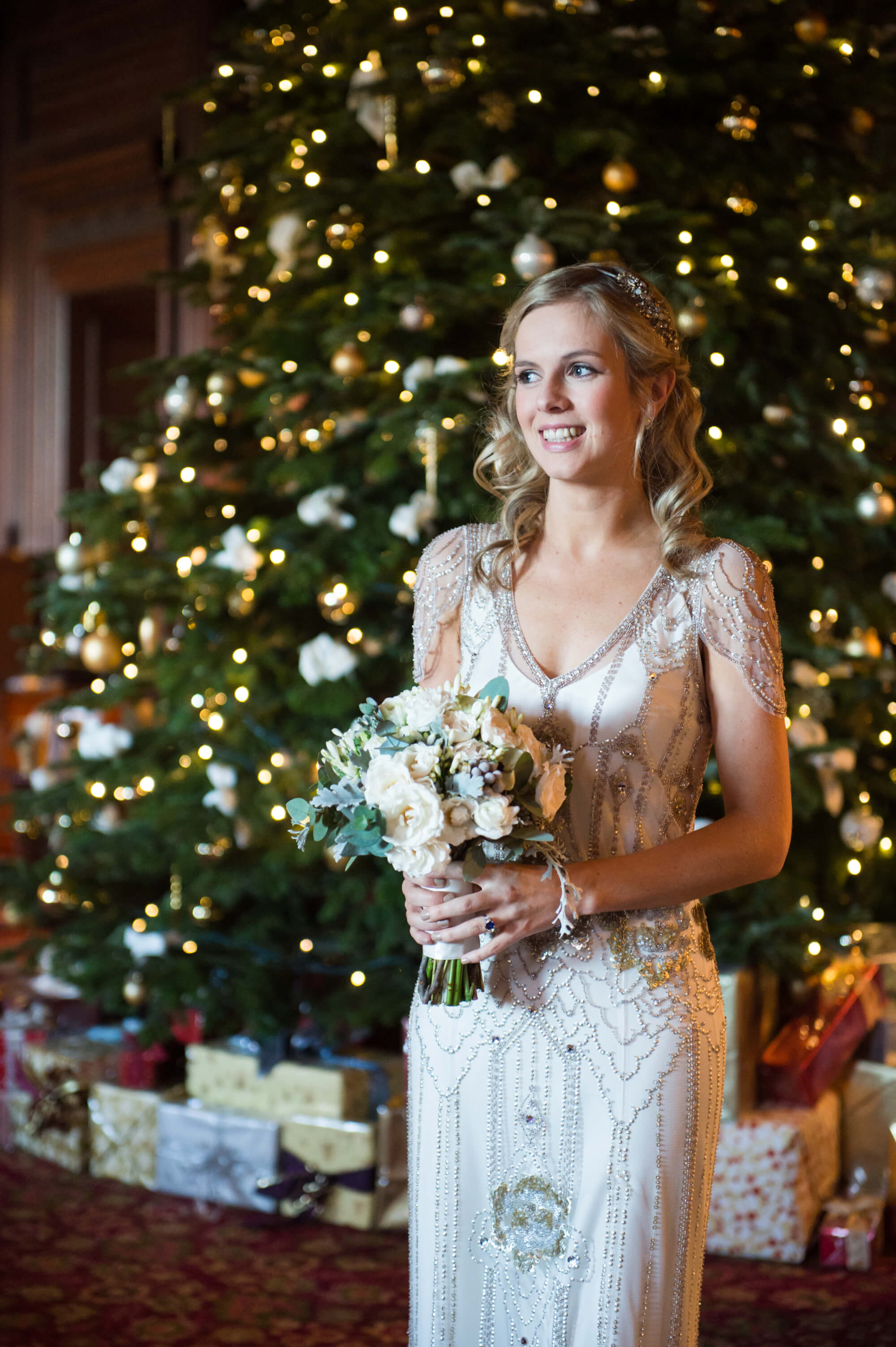The bride standing in front of a Christmas tree at Hedsor House