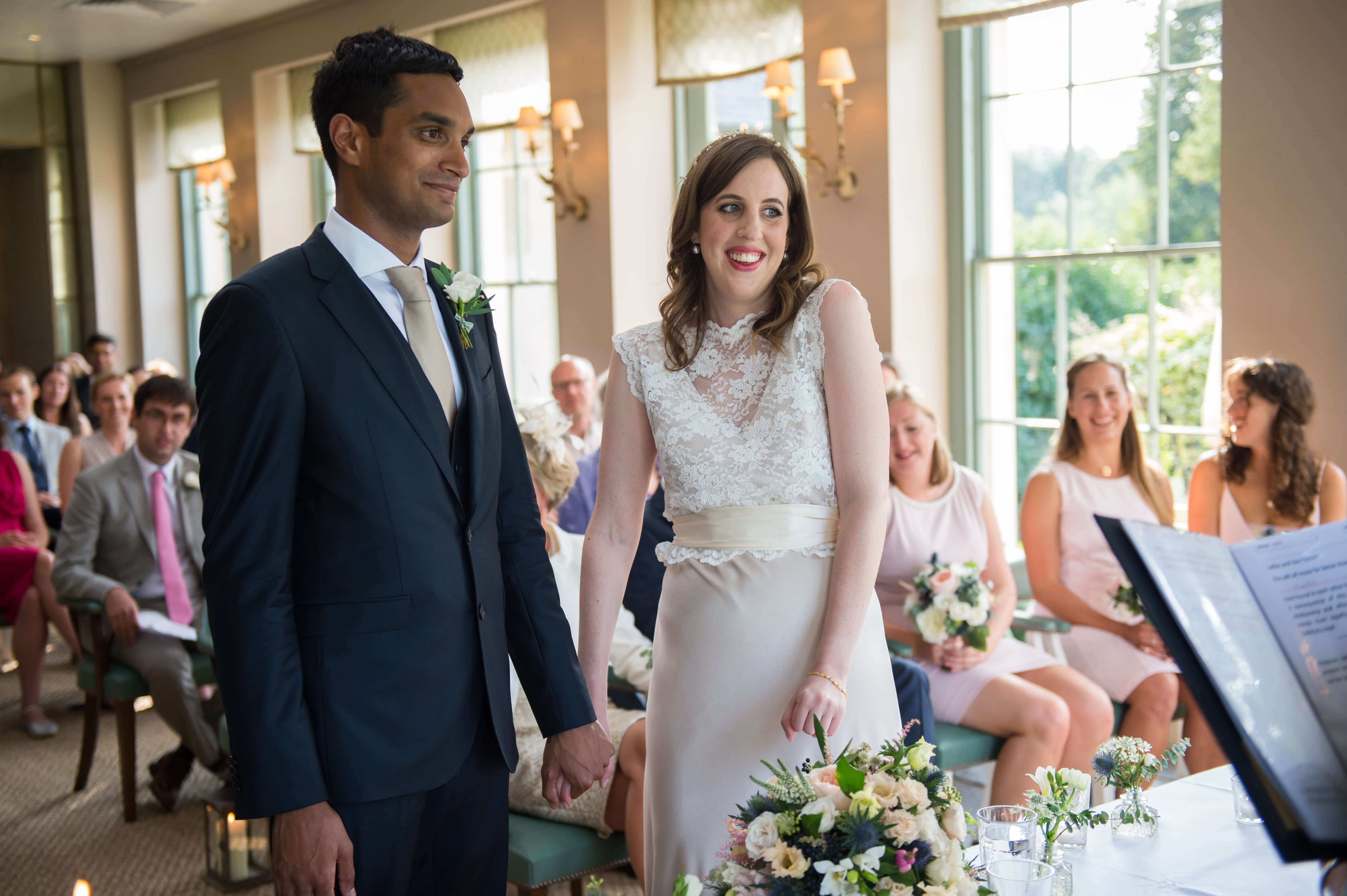 bride and groom getting married in orangery at babington house in charlie brear dress