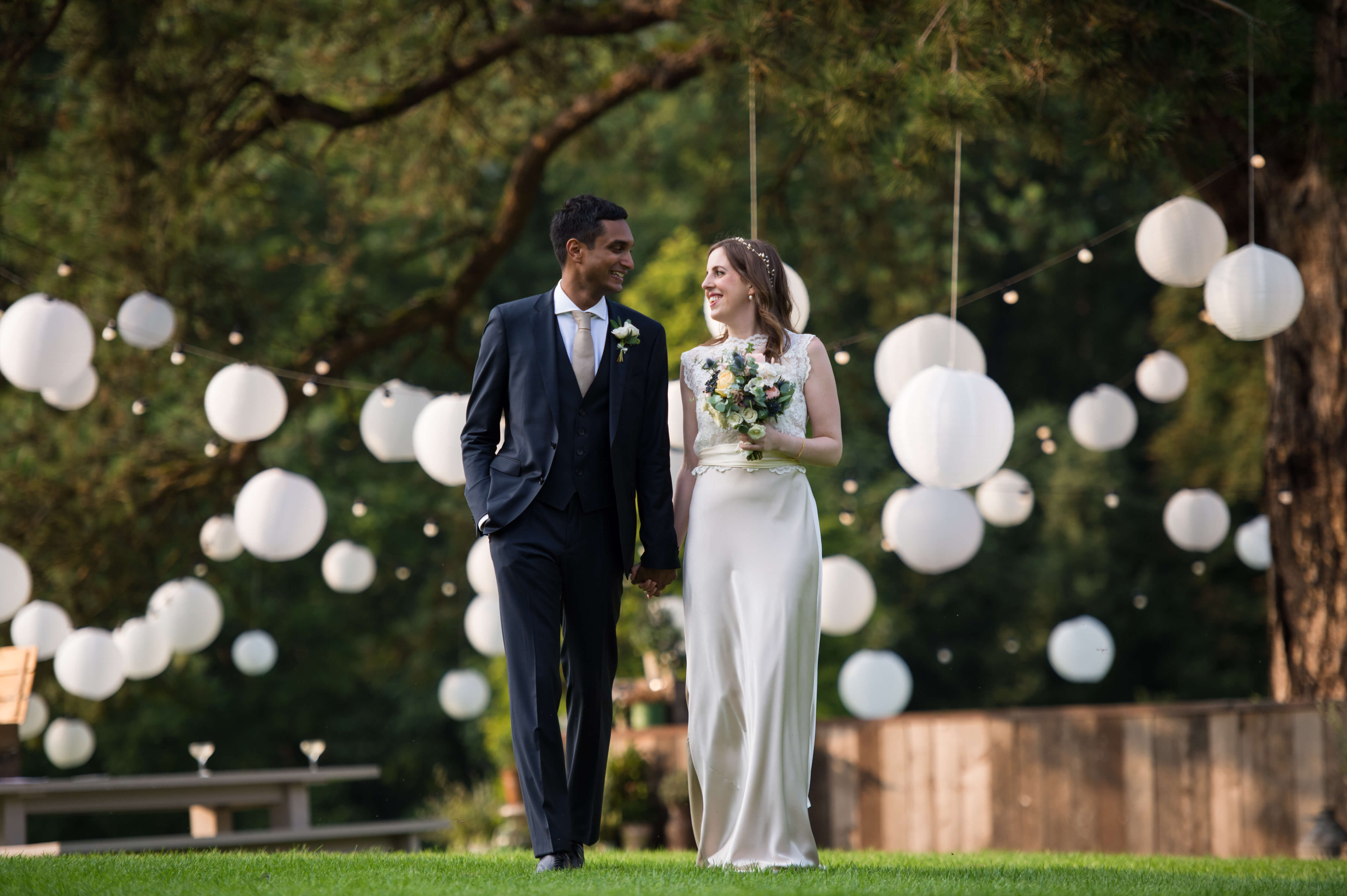 bride and groom portrait at babington house with lanterns in tree and evening sunshine
