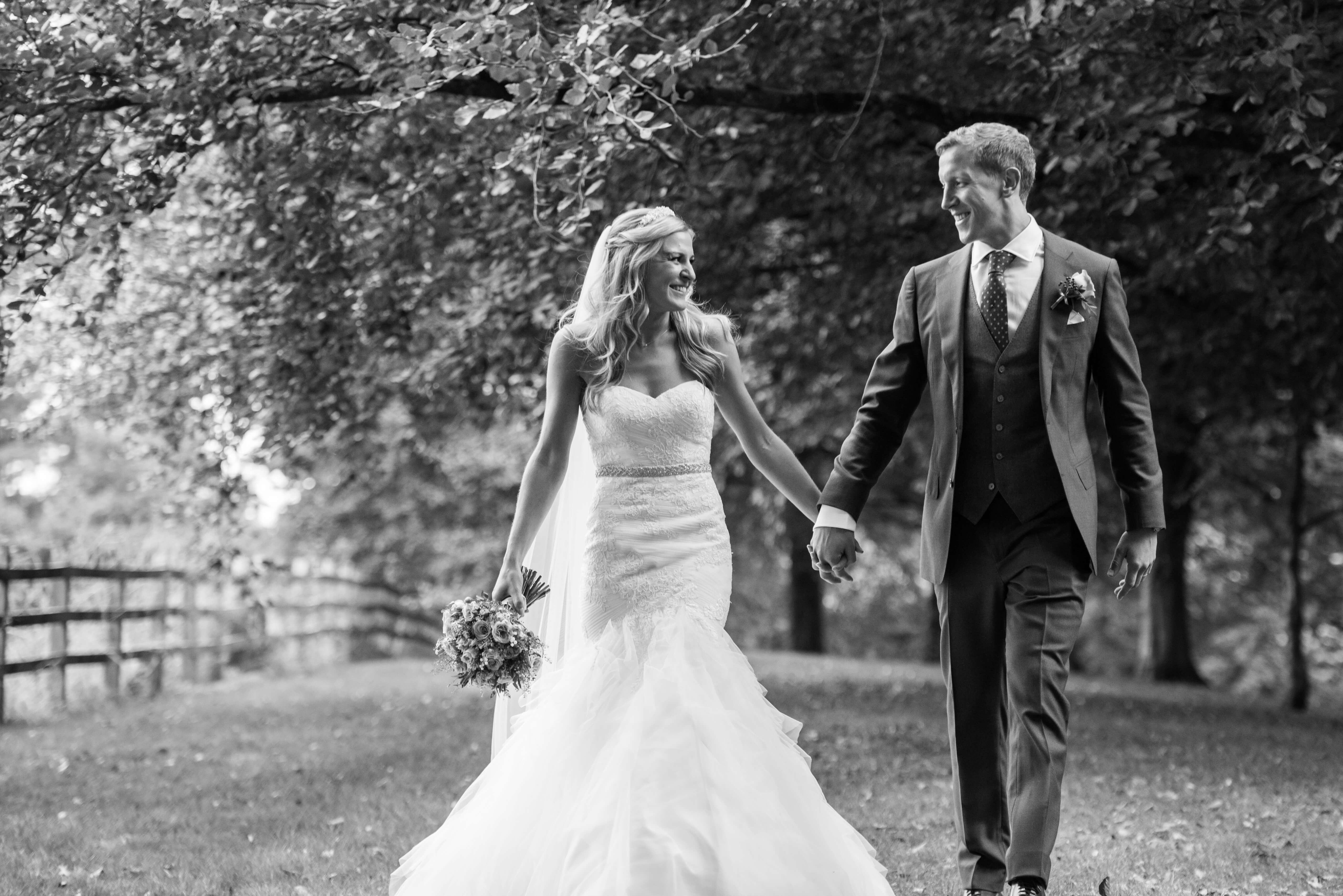 bride and groom in the grounds at babington house in somerset following their wedding ceremony