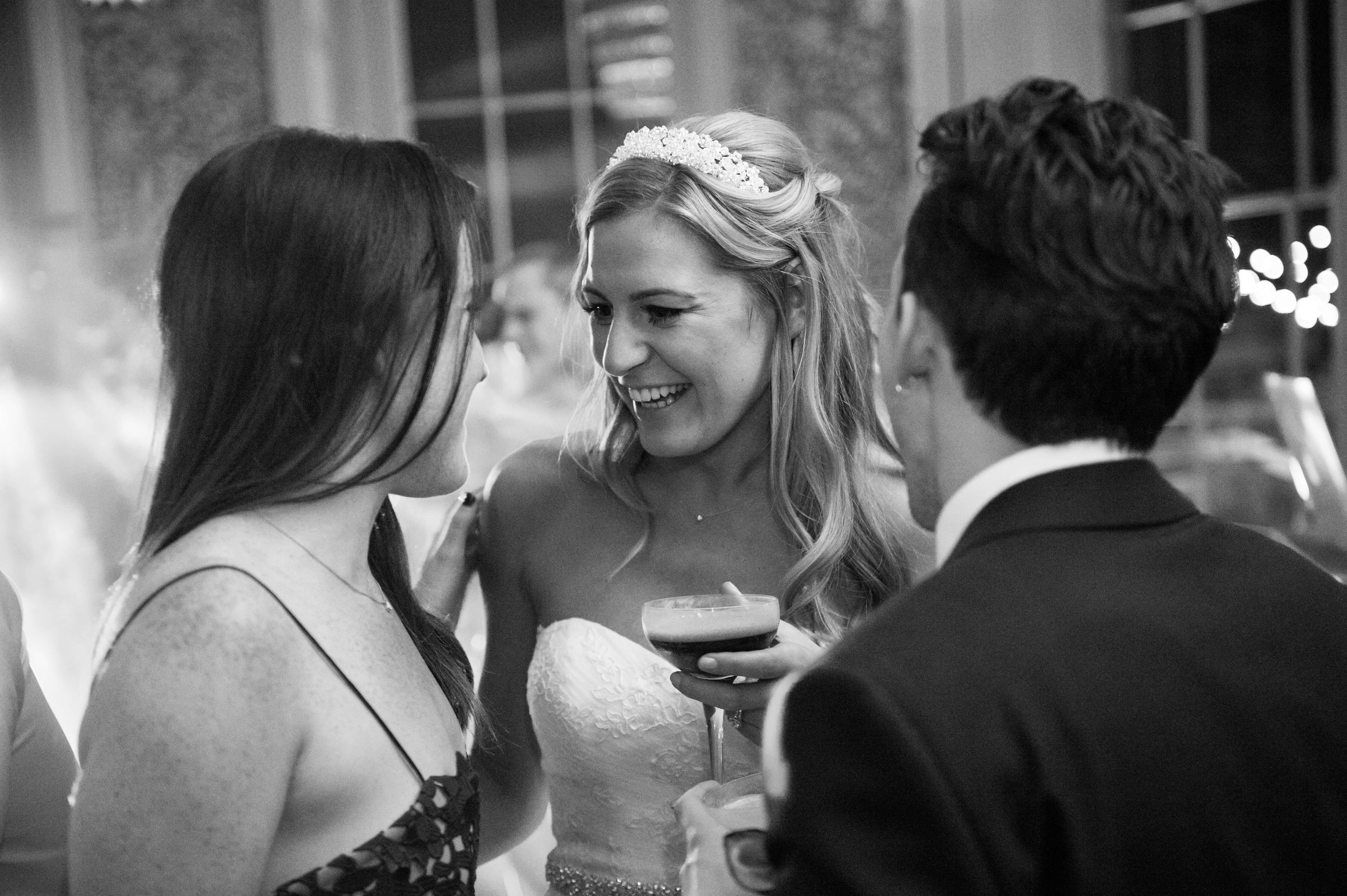 bride drinking an espresso martini in the bar at babington house during her wedding reception