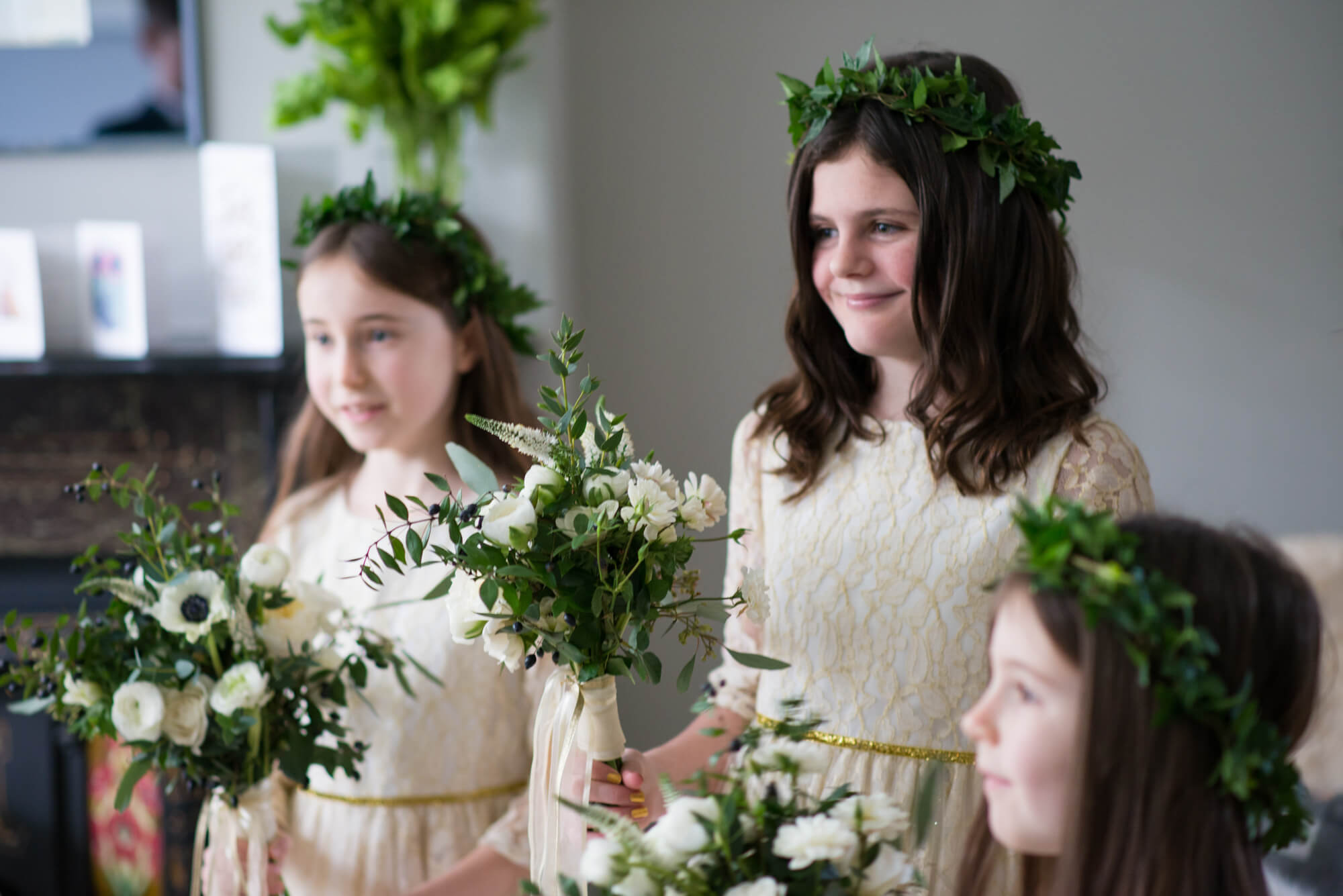 flower girls wearing flower crowns waiting for the wedding photographed by especially amy wedding photography
