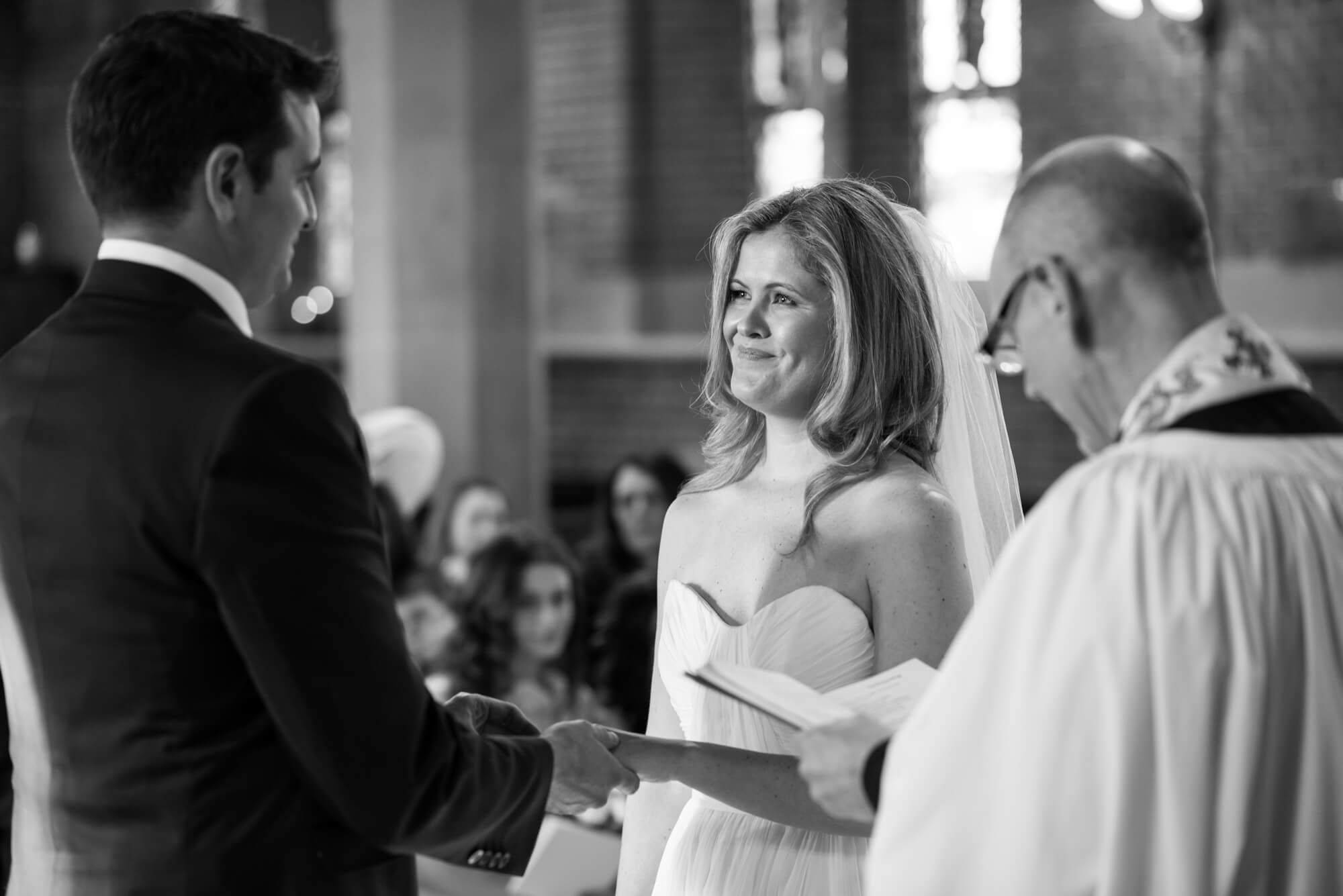 bride and groom exchanging rings at st marys church in putney photographed by especially amy
