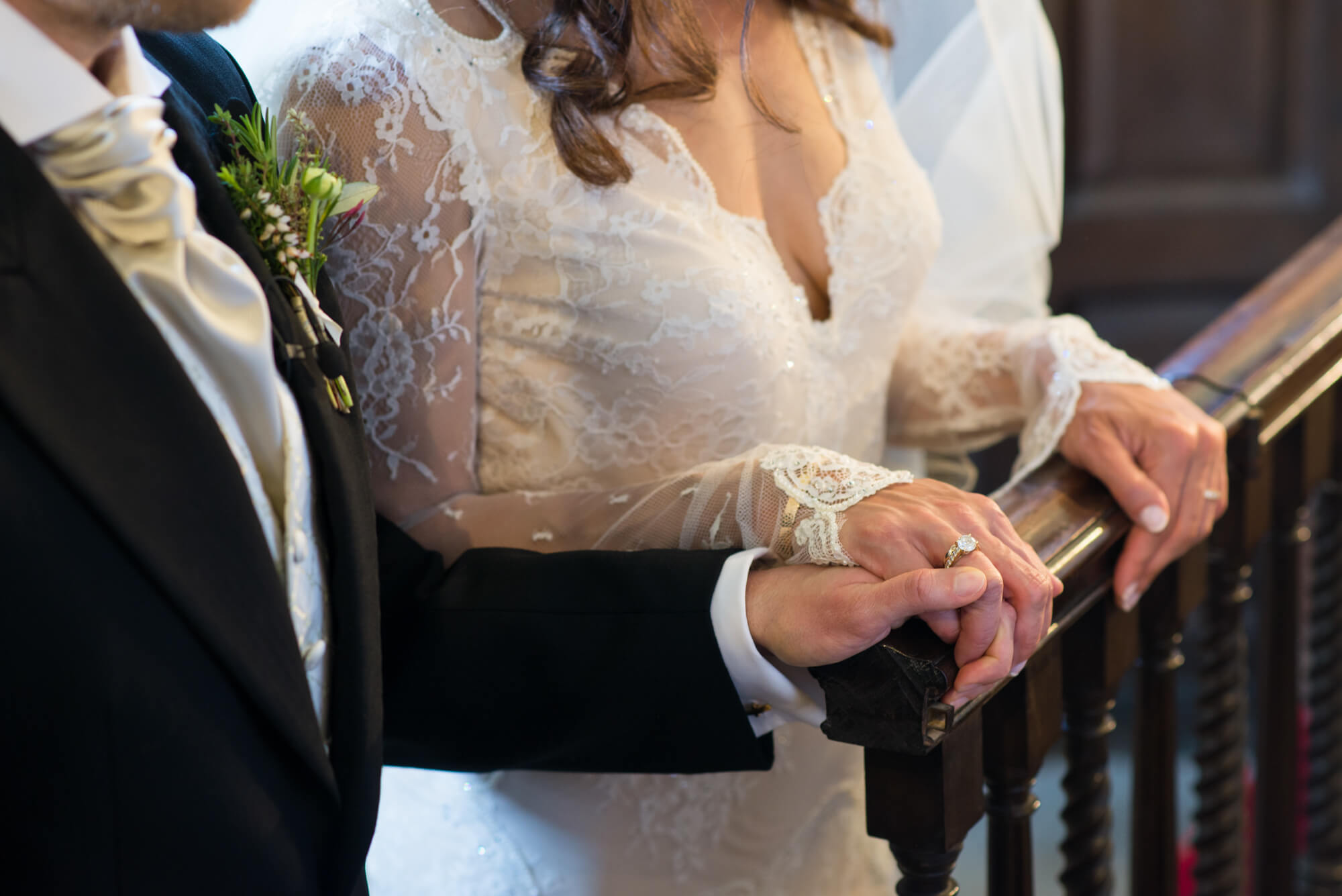 bride and groom holding hands while praying during their wedding at babington house