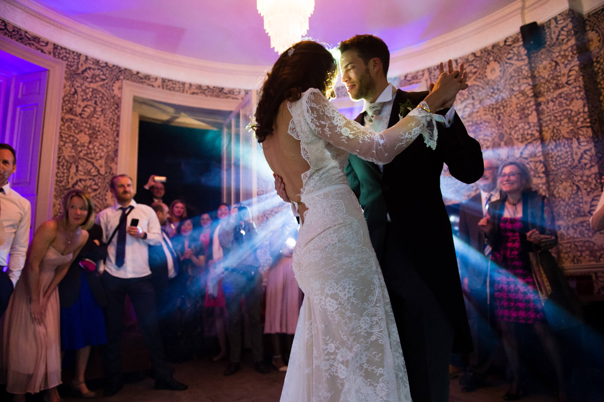 first dance in the bar at babington house wedding in lace dress with disco lights and stylish entertainment