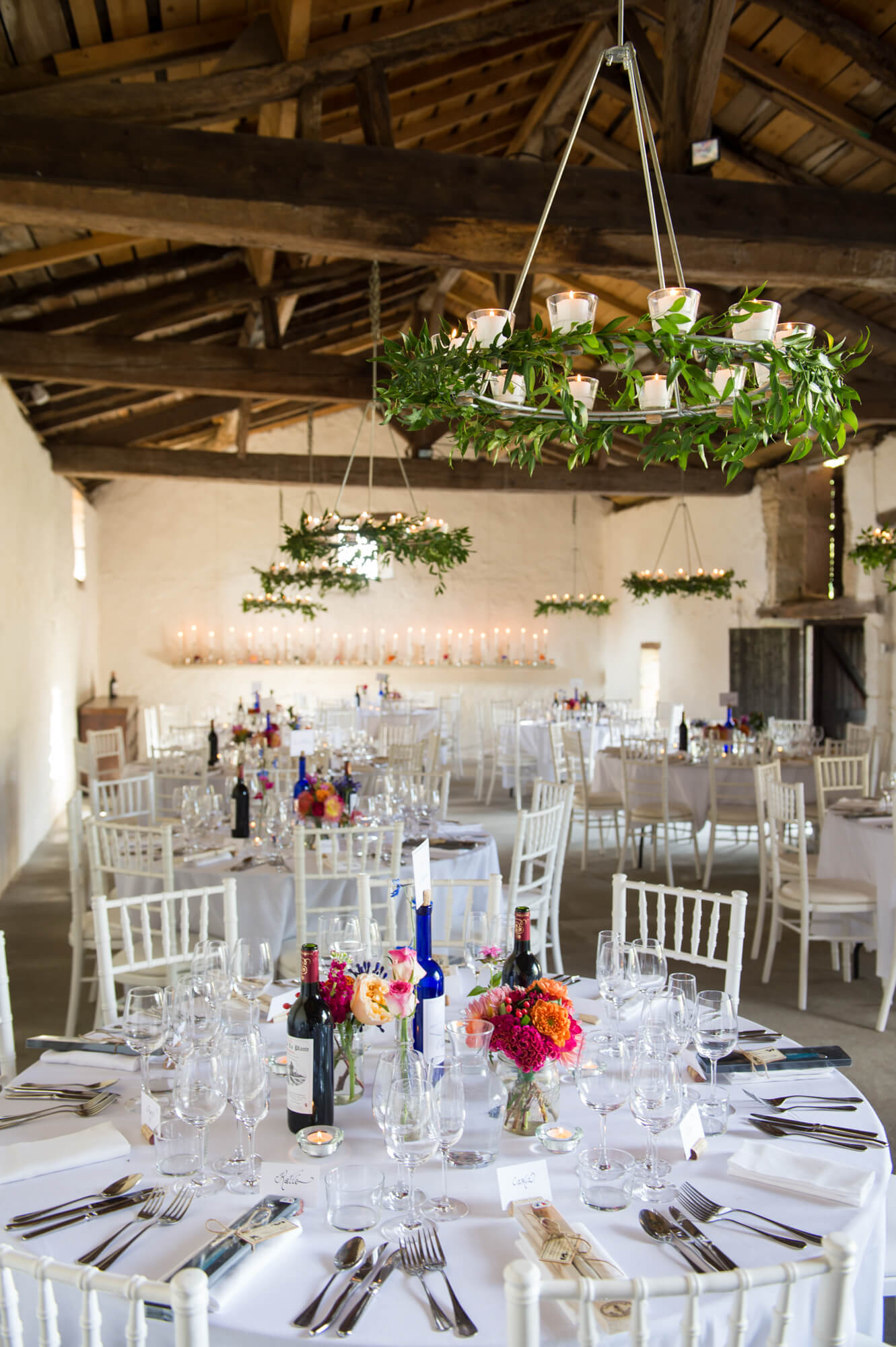 floral tealight chandeliers and bright flowers on the tables at chateau rigaud