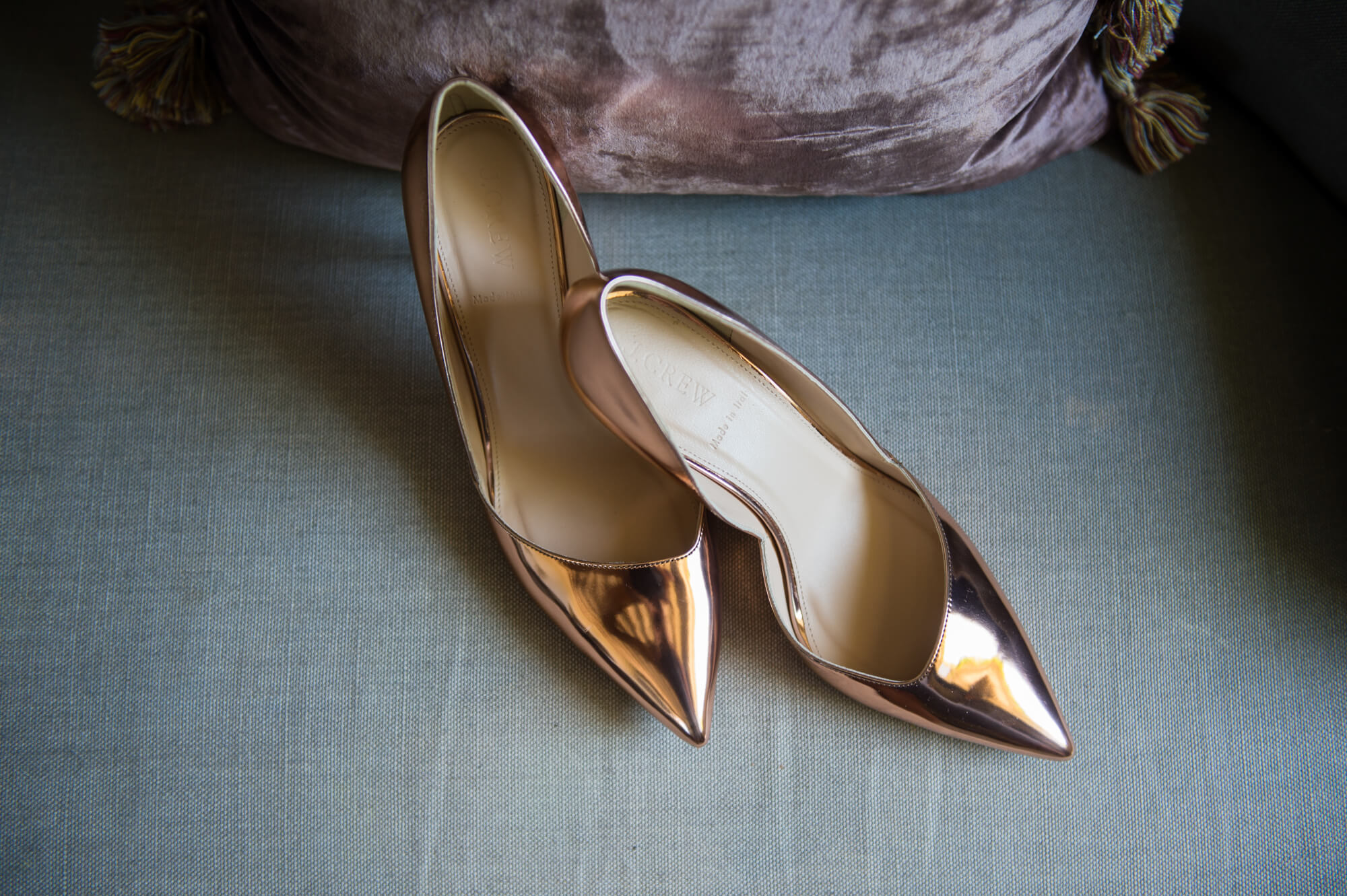 gold wedding shoes on the sofa at chateau rigaud