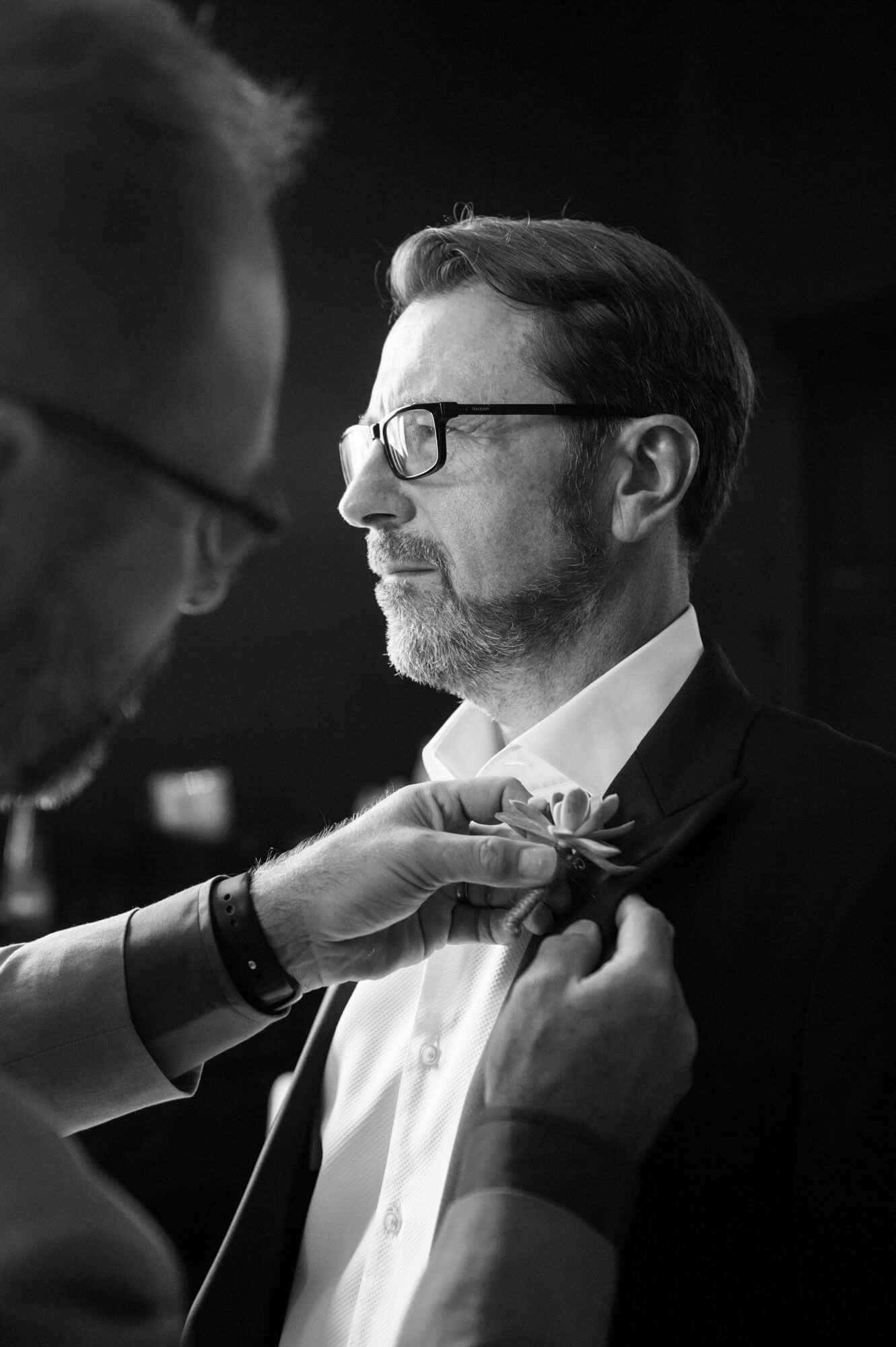 best man fixing the grooms button hole at chateau rigaud