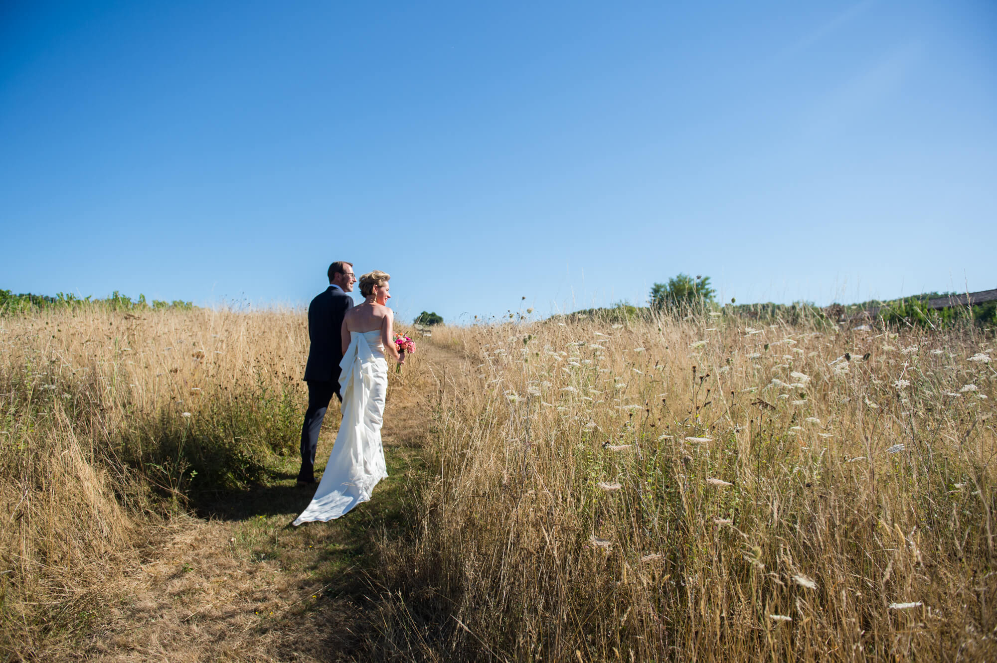 A bride and groom walking in the French countryside