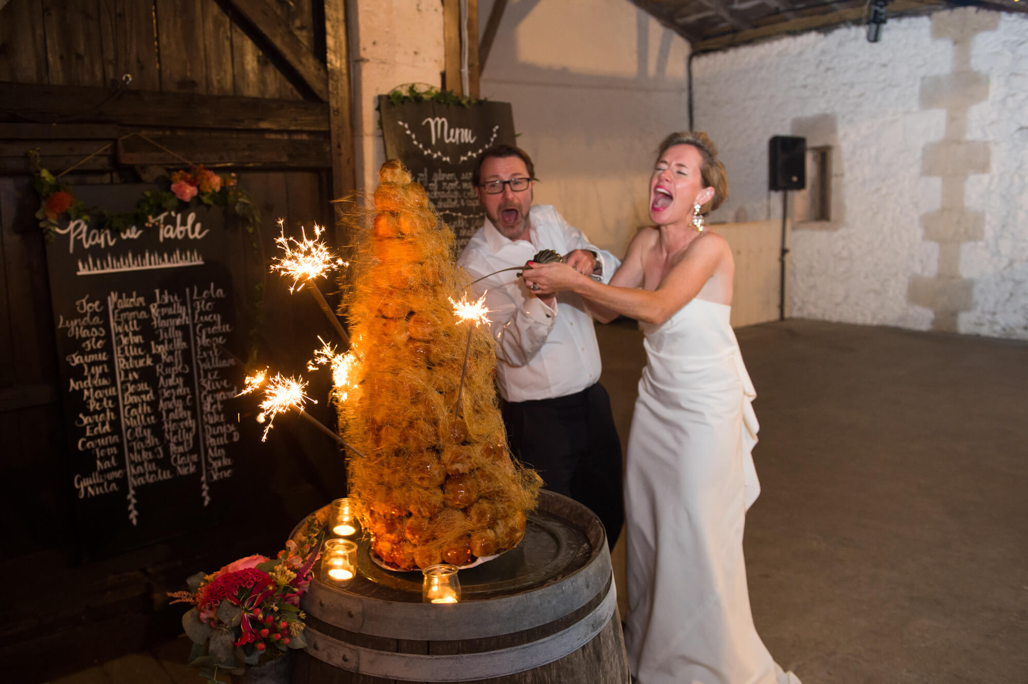 A sugar spun tall wedding cake is about to topple over 