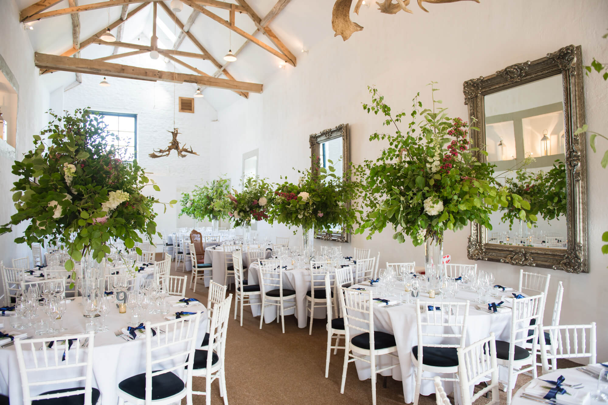 The barn at Merriscourt ready for a wedding with florals by Rowan Blossom hanging from the ceiling