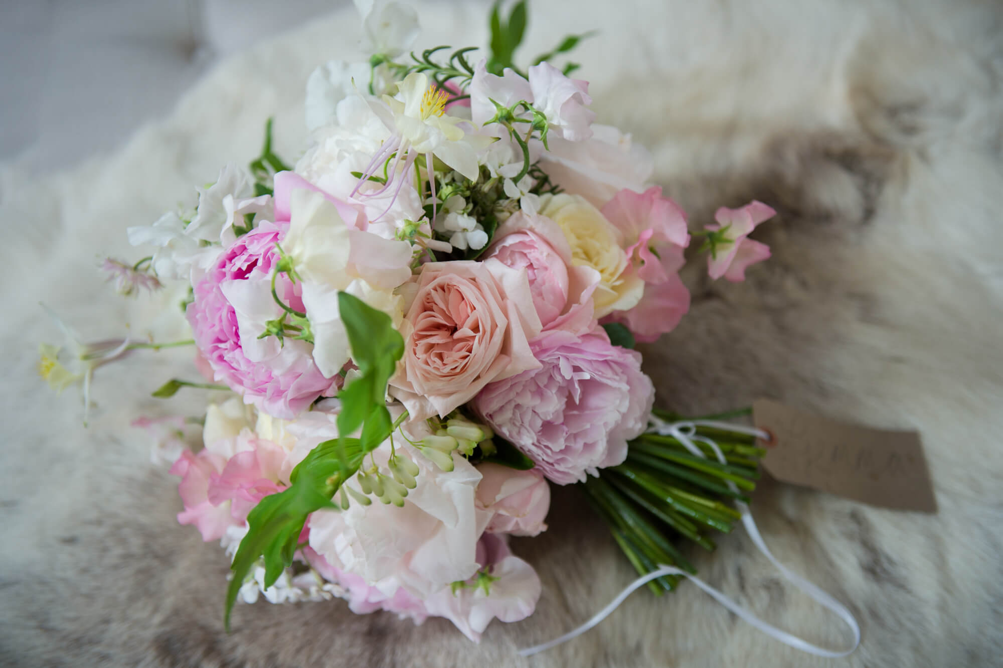 A pale pink and white wedding bouquet by Rowan Blossom