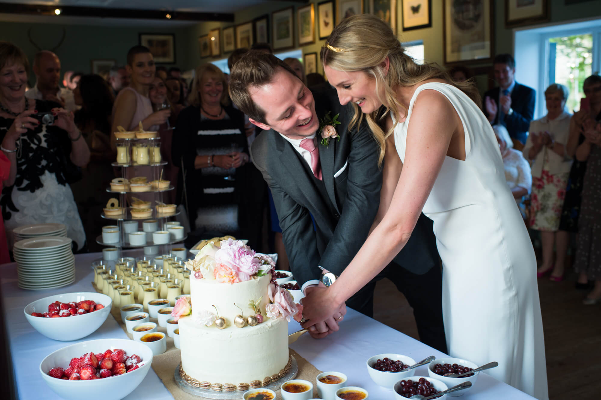 A bride and groom cutting their Lily Vanilli wedding cake