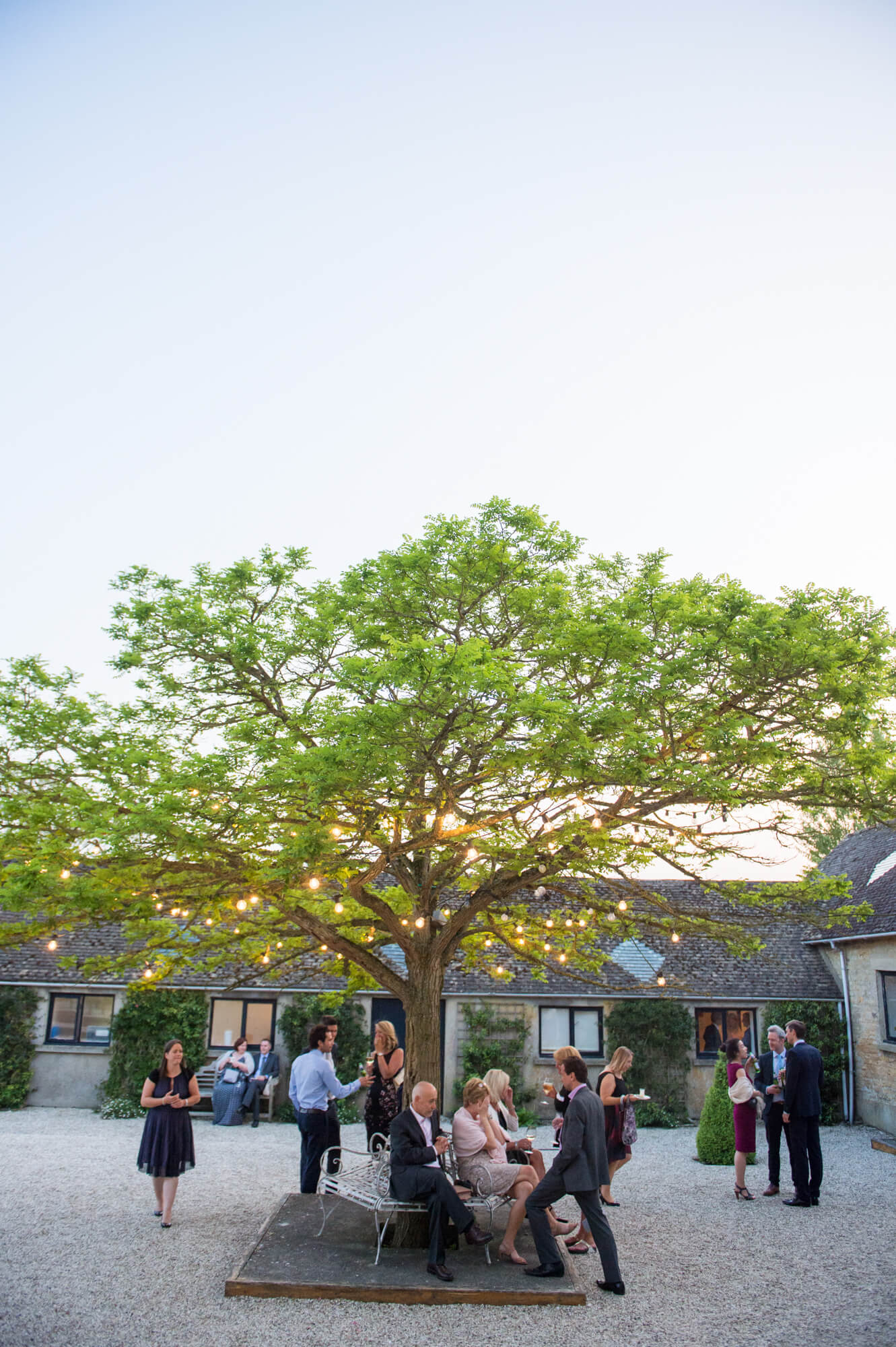 The sun setting over Merriscourt with guests enjoying the courtyard 