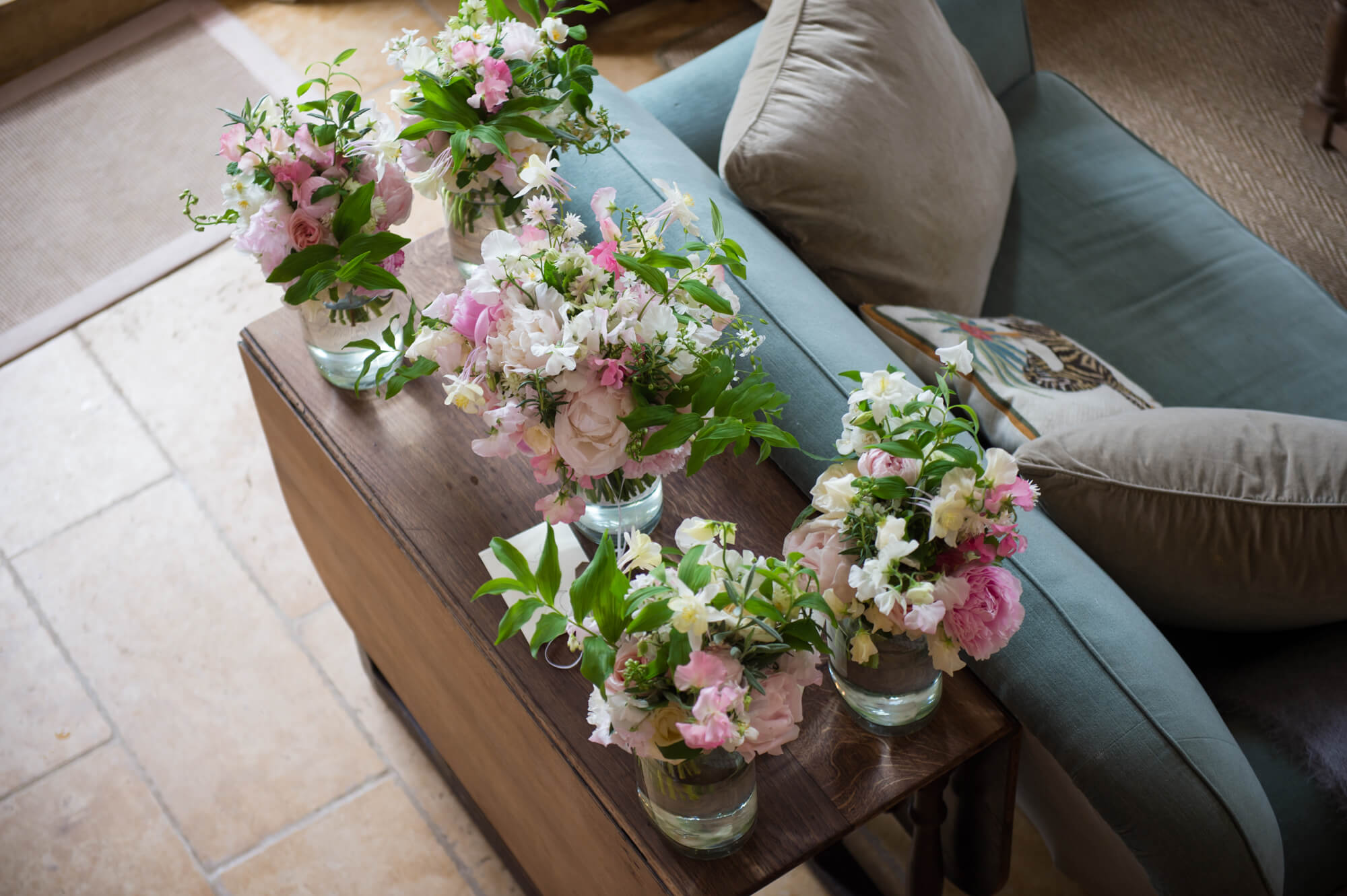 Wedding flowers by Rowan Blossom in vases on a table 