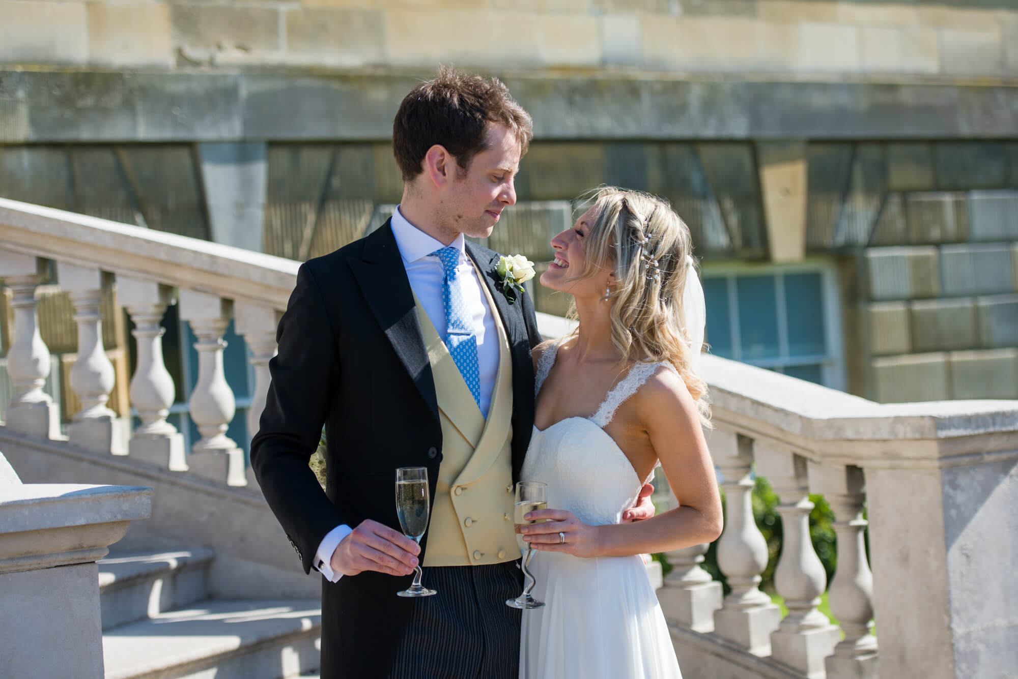 A couple standing on the steps having their wedding photography taken at Botleys Mansion