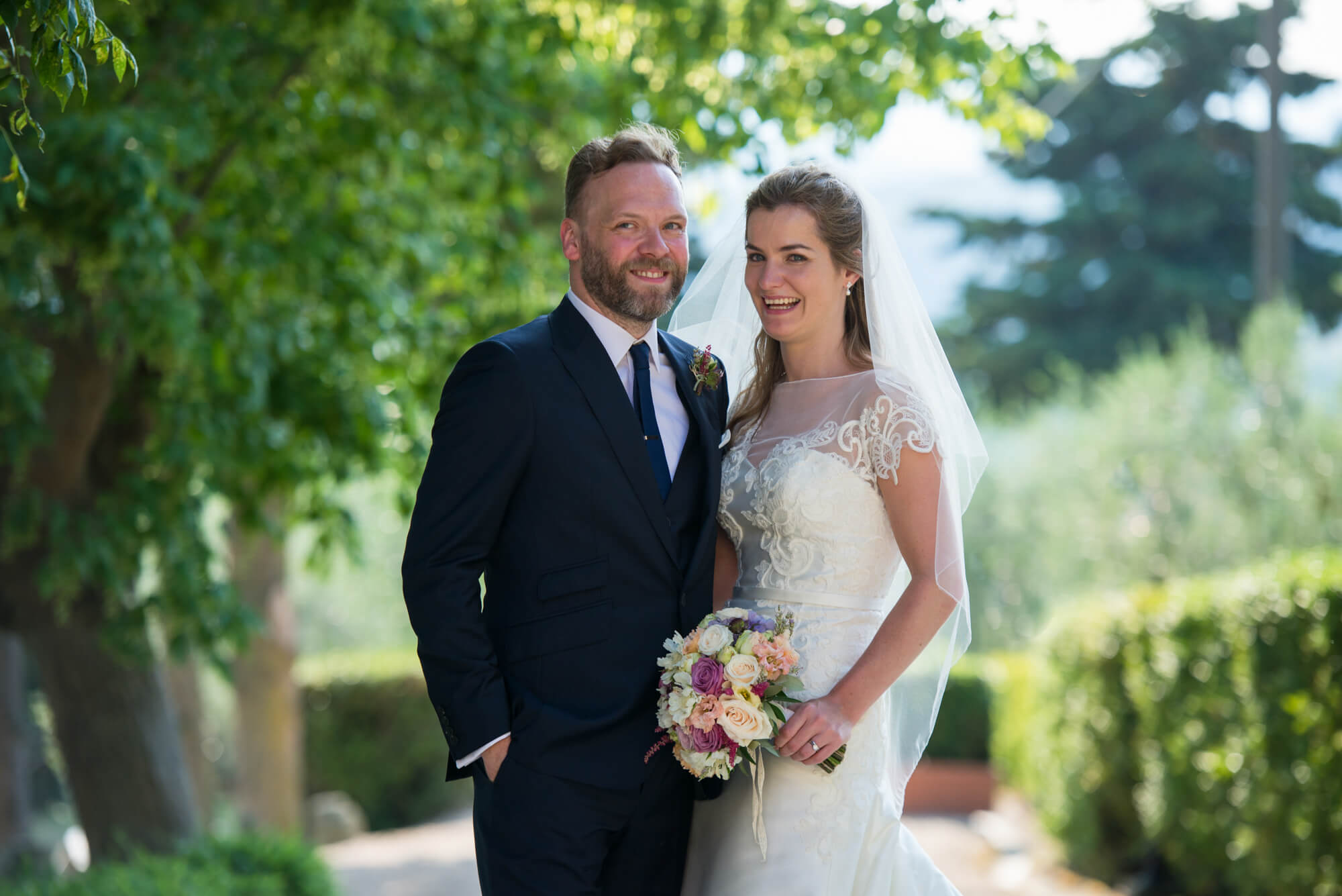 A bride and groom having their wedding photography taken in the gardens of fattoria di cinciano