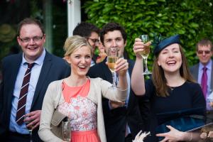 guests with champagne at wedding reception in cambridge clare college